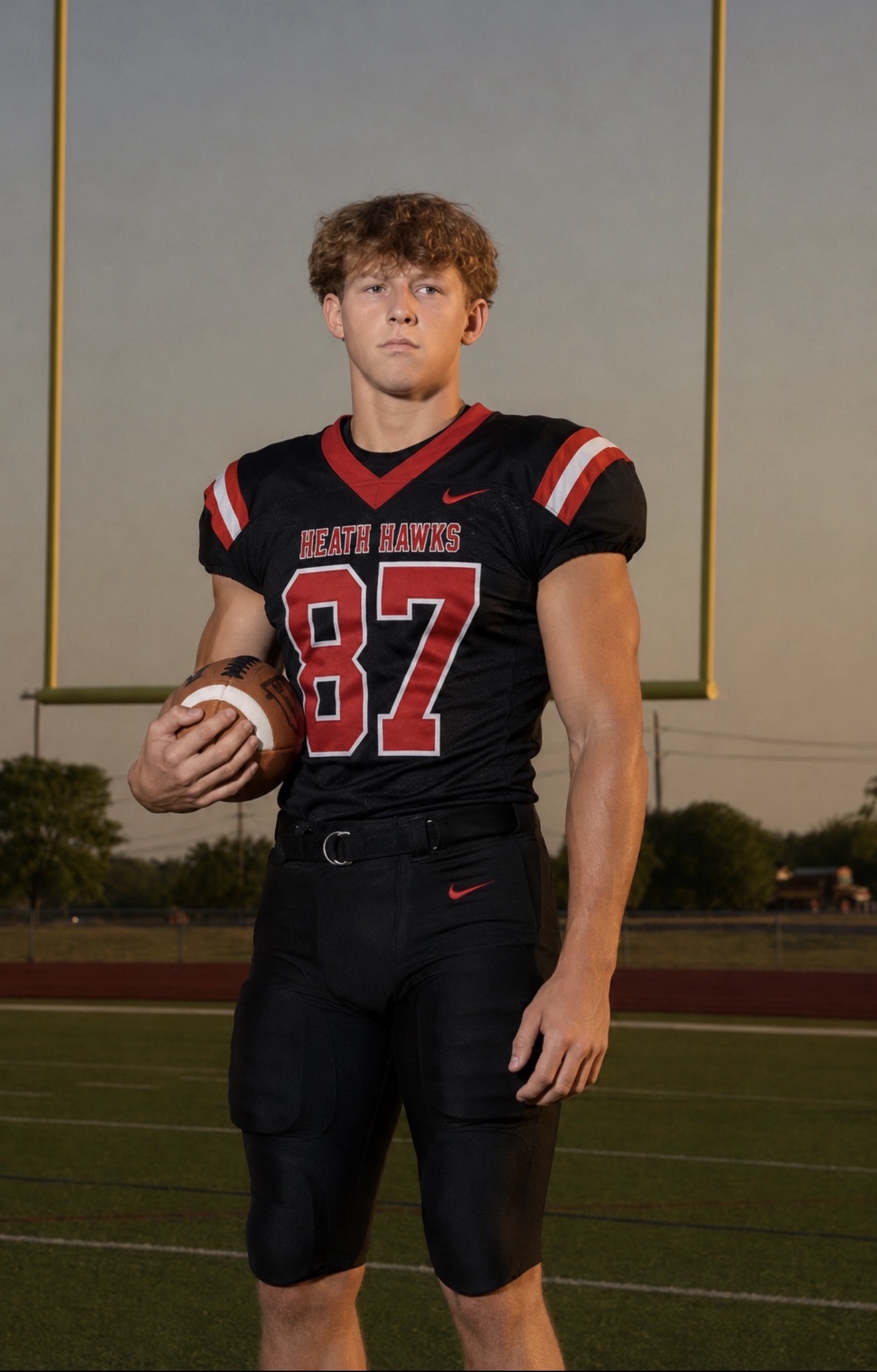 Tristan Libby in Heath Hawks jersey 87 holding a football